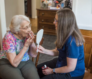 Touching up lipstick with the help of an aide: exceptional memory care outside a dementia nursing home