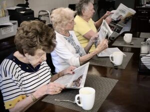 Residents reading the paper